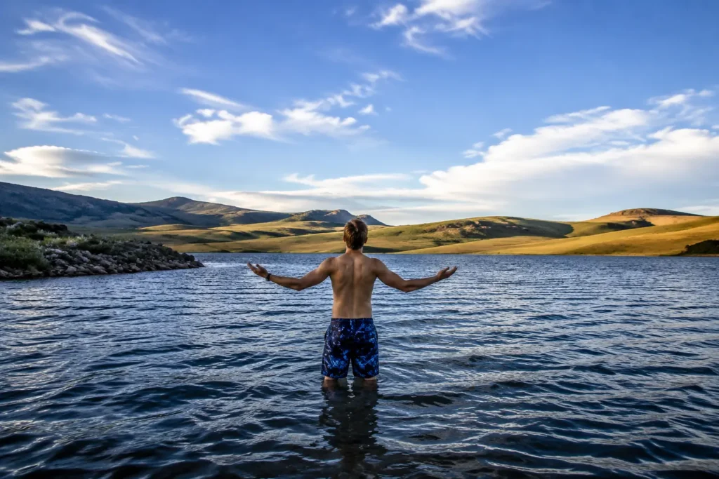 Man wading alone into the wild and isolated Green Mountain Reservoir near Heeney Colorado