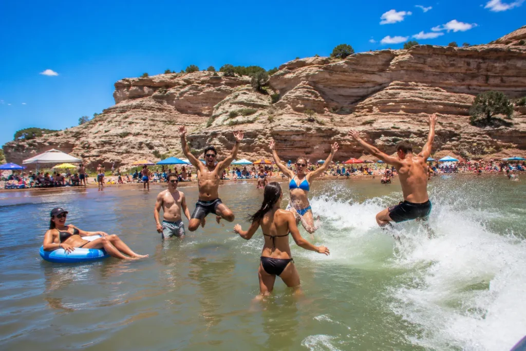 Group of people swimming and playing at Pueblo Reservoir Rock Canyon Swim Beach in southern Colorado