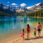 Swimming lakes in Colorado. Family walking on a sandy beach at a stunning swimming lake in Colorado with mountain backdrop