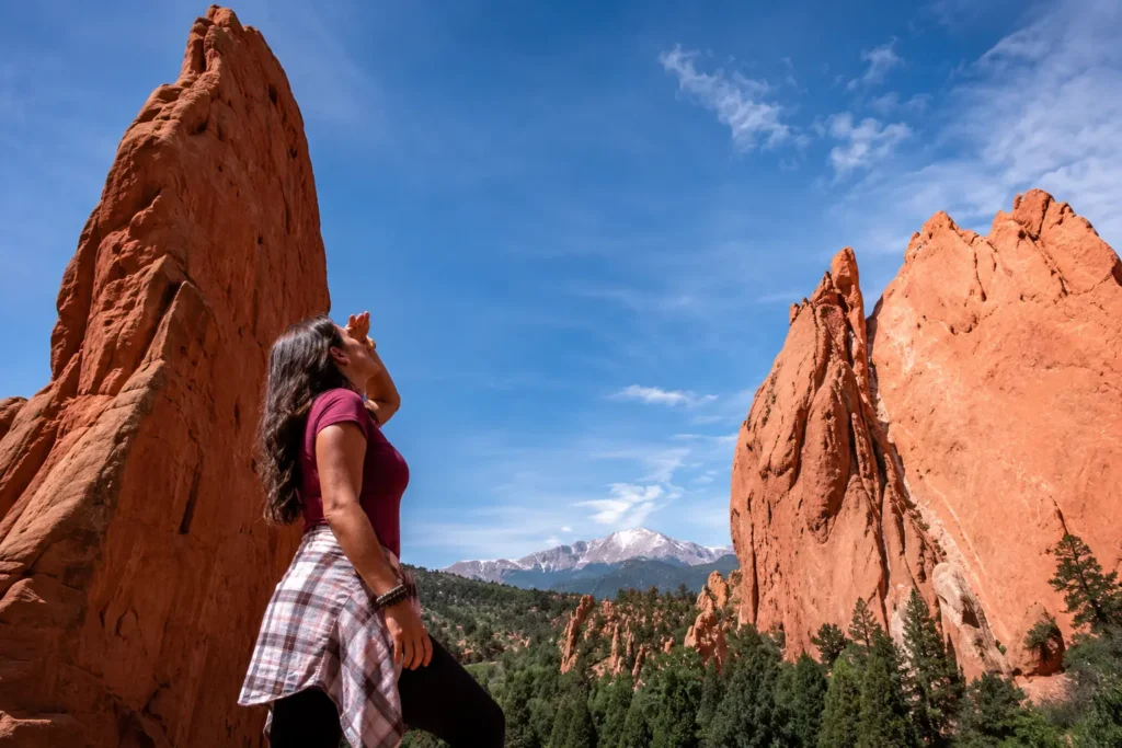 Woman looking up at the red rock formations of Garden of the Gods near Pikes Peak